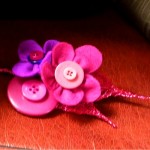 cerise and purple felt and button corsage From £12.50 cerise and purple felt buttonhole