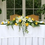 yellow and white ceremony arrangement